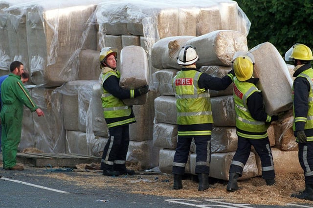 Firefighters help remove the debris after a lorry shed its load on the Stourton roundabout off the M621.