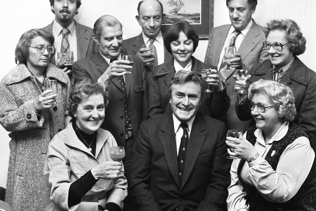 Cancer specialist at Wigan Infirmary, Dr. Philip Silver, is toasted by hospital officials on his retirement on Thursday 7th of February 1980.
