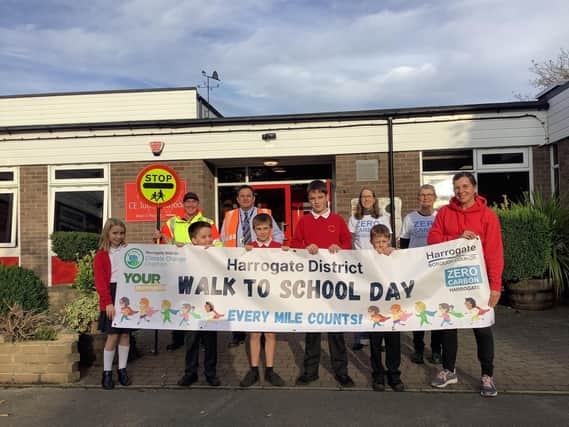 Holy Trinity Infant and Junior Schools in Ripon proudly show off their 'Walk To School Day' banner