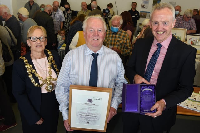David Shallcross, centre, receiving the Queen's Award for Voluntary Service from Deputy Lieutenant Steve McGirk and Mayor of Wigan Coun Yvonne Klieve, left.