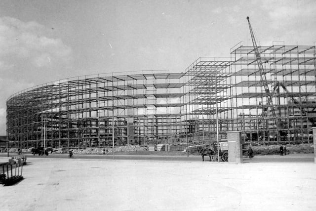 August 1938. A wide-view of steel frame-work construction of the flats. On the left, would be Oastler House, coming to Priestley House on the right. This is from the newly-built bus station on St. Peter's Street.