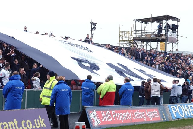 PNE fans pass a giant flag along the stand in the March 2008 visit to Blackpool