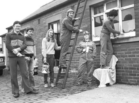 Conservation volunteers get to work on a building on Bridge Street in this snap from February 1985.