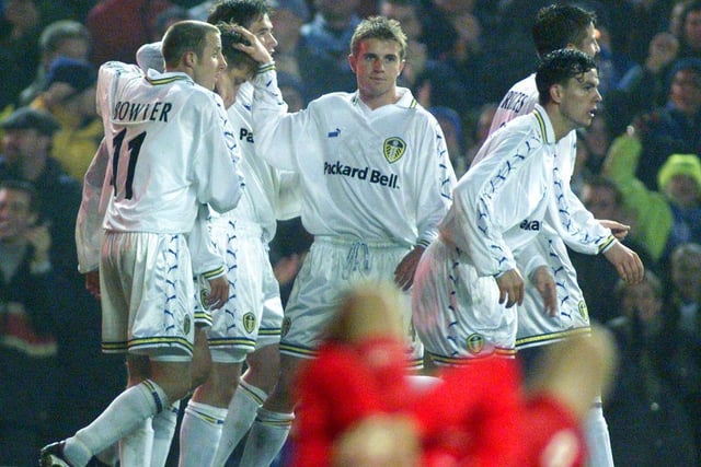 The players celebrate Alan Smith's goal.