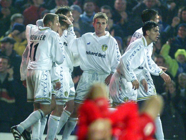 The players celebrate Alan Smith's goal.