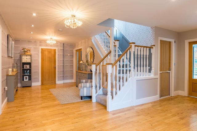 Enter into the impressive large entrance hallway which accommodates a modern WC beneath the staircase and gives access to reception rooms including the formal living room, a play room and the orangery/games room.