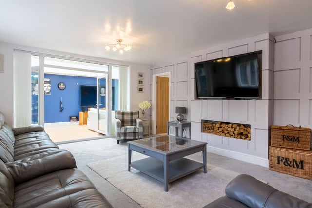 The main living space is a warm, cosy and inviting room with modern finishes. It features a log burner and has double doors through to the orangery.