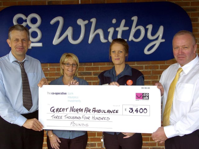 Staff at Whitby Co-op present a cheque to the Great North Air Ambulance.