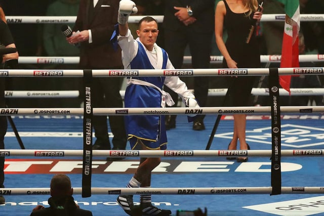Once the featherweight title-holder, boxer Warrington walks into the ring to the sound of Marching On Together.