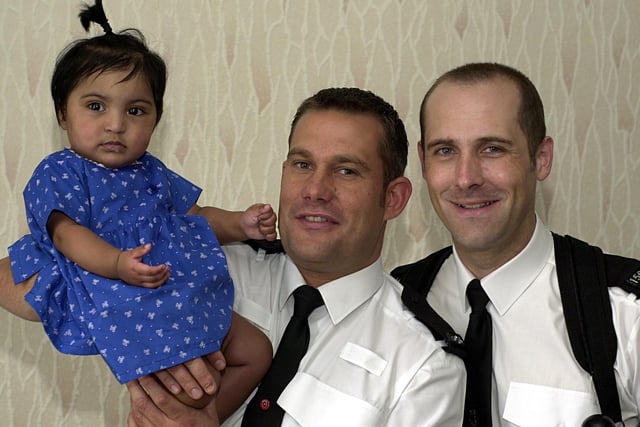 PC Neil Bottomley (left) and PC Paul Morris are pictured with seven month old Aishah Hussain who they rescued from a house fire in Beeston.