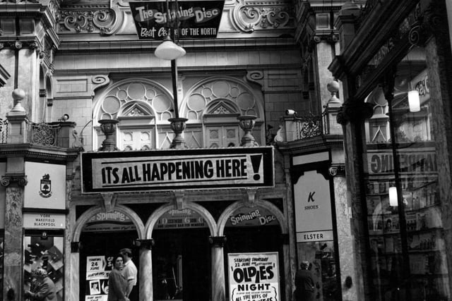 Close up of the entrance to Spinning Disc in County Arcade in 1967 with sign saying 'its all happening here'.