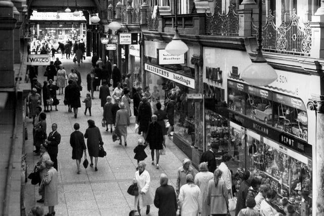 County Arcade in 1967.Pictured on the right is the toy shop, Smart and Son which included the Doll's Hospital, then Salisbury's Handbags. Moving in the direction of Briggate (background) is Cardis Pork Butchers, then opticians H.Y. Manley Ltd.