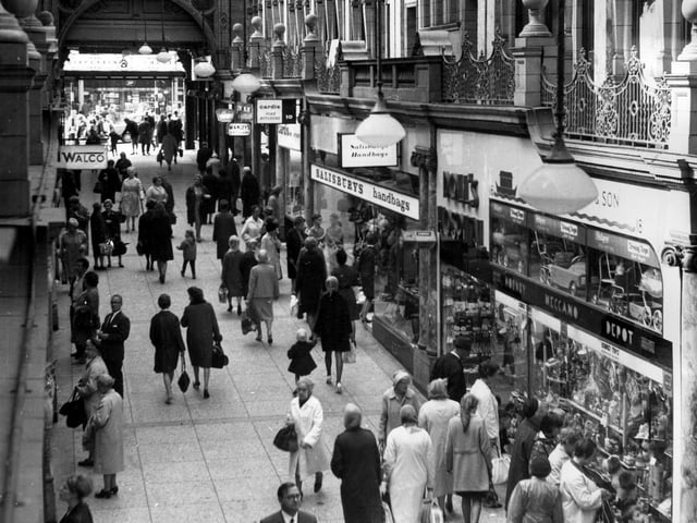 County Arcade in 1967.Pictured on the right is the toy shop, Smart and Son which included the Doll's Hospital, then Salisbury's Handbags. Moving in the direction of Briggate (background) is Cardis Pork Butchers, then opticians H.Y. Manley Ltd.