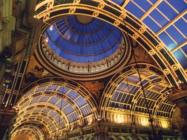 Looking up at the decorative ceiling of the County Arcade, which features a dome in the centre at the point where the County Arcade, which joined by the Cross Arcade. Below the dome are four mosaics which represent Liberty, Commerce, Art and Labour; three of them can be seen here.