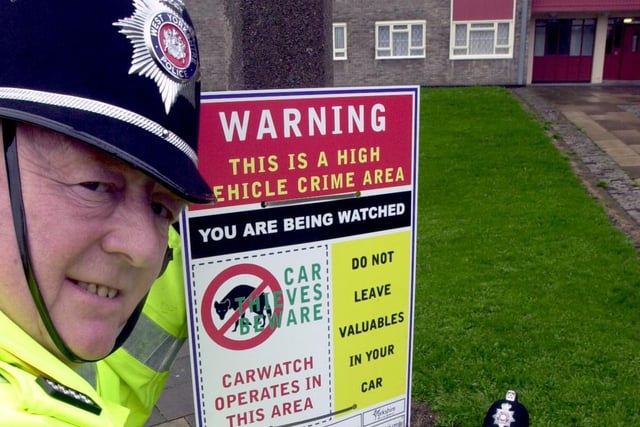 P.C Tony Sweeney (left) helped put up West Yorkshire Police warning signs about vehicle crime around the Lincoln Green area. Looking on is PC Tony Walker (right), section officer at Chapletown.