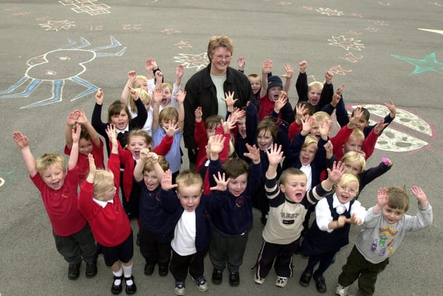 Garforth's Barleyhill Infants headteacher Gill Austerfield and pupils celebrate a £1,000 donation by the school's PTA for playground equipment.