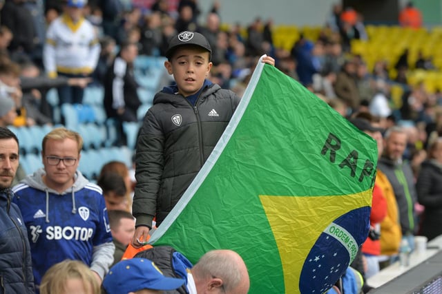 Support for Brazilian star Raphinha in the stands with the Brazil flag.