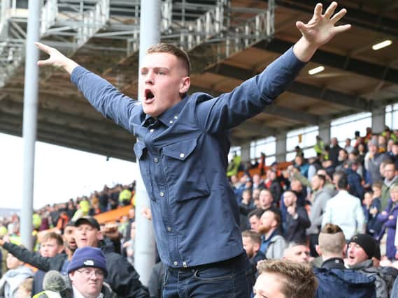 A Preston North End fan gets behind his team at Bloomfield Road