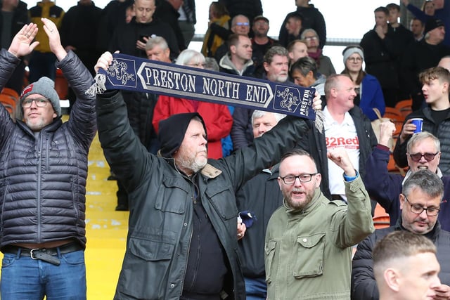 A PNE supporter proudly holds aloft his scarf at Bloomfield Road