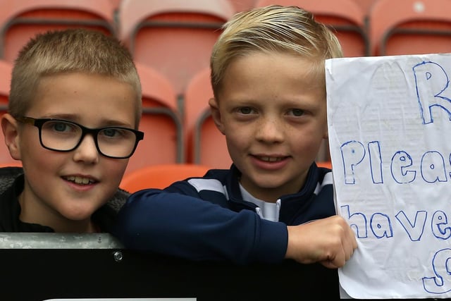 Two young PNE fans hold up a sign asking for Emil Riis' shirt