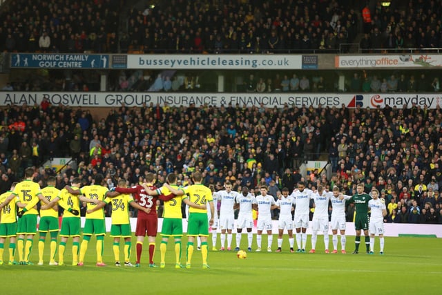 Both sets of players line-up ahead of kick-off at Carrow Road.
