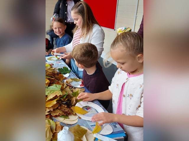 Children make leaf wreaths at Autumn Daze Festival.