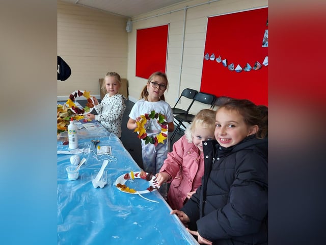 Children make leaf wreaths at Autumn Daze Festival.