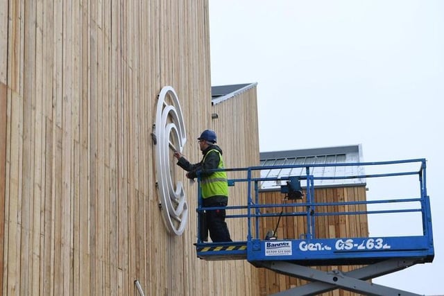The lettering on the food hall being installed