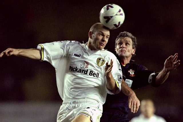 Danny Mills heads clear under pressure from Southampton striker Mark Hughes.