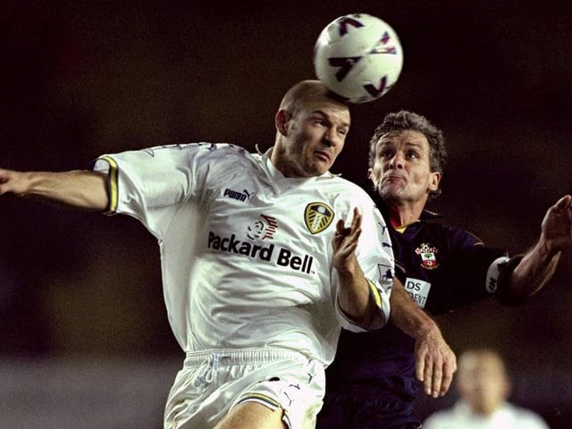 Danny Mills heads clear under pressure from Southampton striker Mark Hughes.