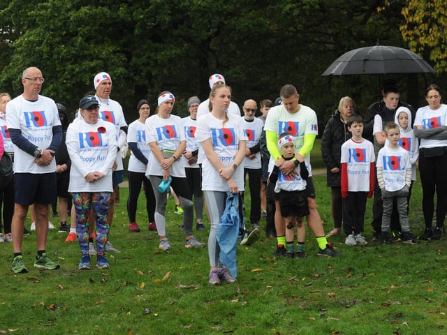 Runners observing a minute's silence before the run.