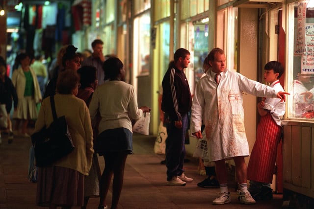 A butcher tries to attract customers to his shop in July 1996.