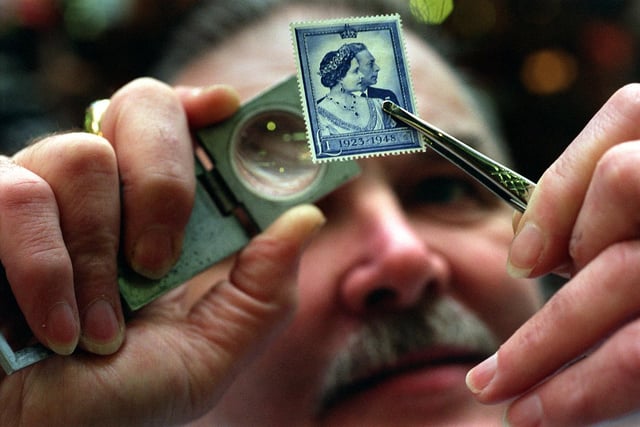 Doug Elliott, of the Kirkgate Stamp Company in the County Arcade checks the glue and perforations on a 1948 Royal Silver Wedding stamp.