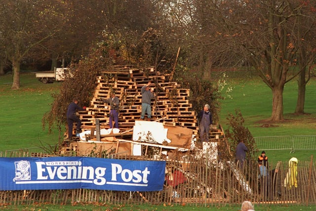 The bonfire in Roundhay Park gets even larger as workmen add yet more wood to the pile.