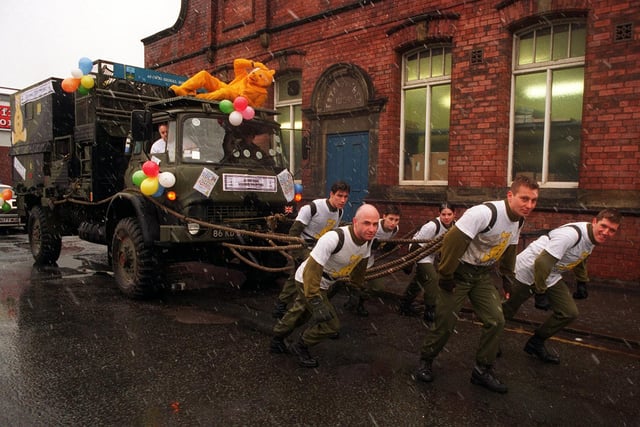 49th Signals are pictured pulling a truck from Leeds city centre to Pudsey to raise money for Children In Need. Pictured are Cpl John Bailey, Sig Nick James, Sig Terry Collet, Sig Mel Firth, Cpl Ian Eastwood, and Cpl Simon Haines.