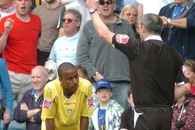 Fabian Delph receives a yellow card during Leeds United's League One play off semi final first leg clash against Millwall at The Den in May 2009.