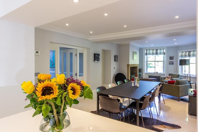 The stylish dining room with family area, through from the kitchen.