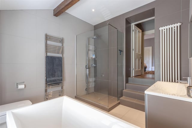 A modern bathroom with a stand alone shower cubicle.