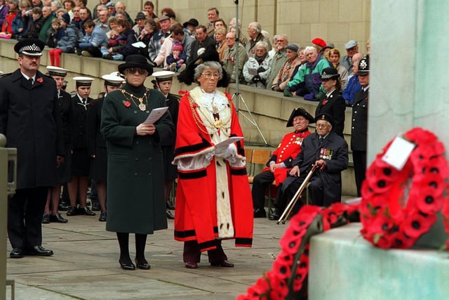 With a Chelsea Pensioner and war veteran looking on, The Lord Mayor and Lady Mayoress of Leeds, Coun Mrs Linda Middleton and Mrs Kathleen Thompson, pay their respects at the war memorial in the Garden of Rest.