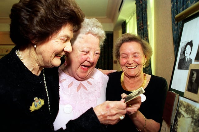 The Queens Hotel hosted a reunion of wartime NAAFI girls. Pictured, from left is organiser Jean Gibson, Gwladys Morris and Peggy Barrett looking at some of the old photos.