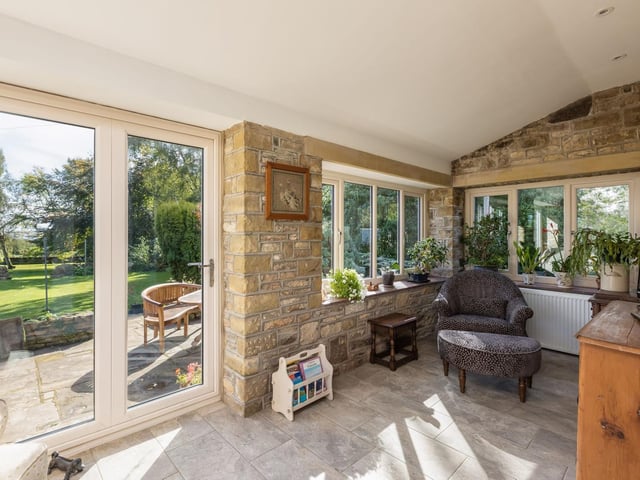 Doors lead out to the established gardens with country views beyond.