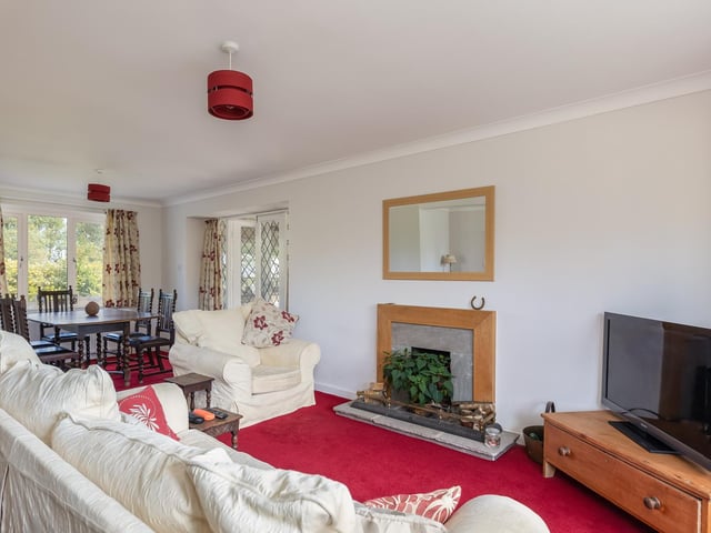 A fireplace is a central focal point within the lounge.