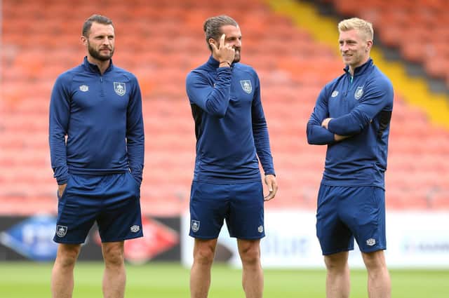 Erik Pieters, Jay Rodriguez and Ben Mee of Burnley inspect the pitch prior to the Pre-Season Friendly match between Blackpool and Burnley at Bloomfield Road on July 27, 2021 in Blackpool, England.