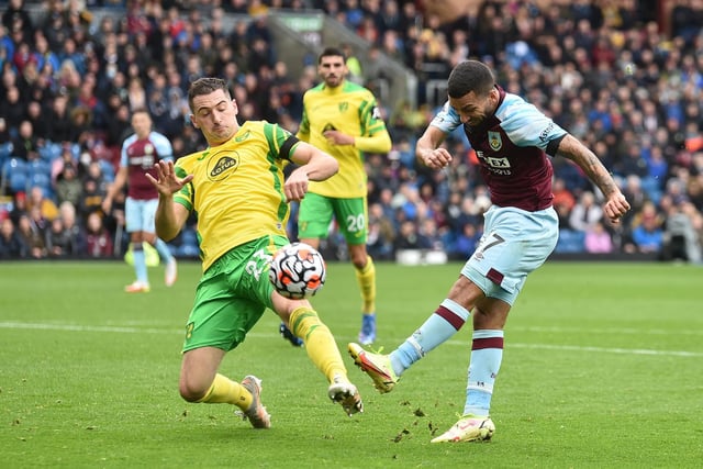 Aaron Lennon of Burnley shoots whilst under pressure from Kenny McLean of Norwich City during the Premier League match between Burnley and Norwich City at Turf Moor on October 02, 2021 in Burnley, England.