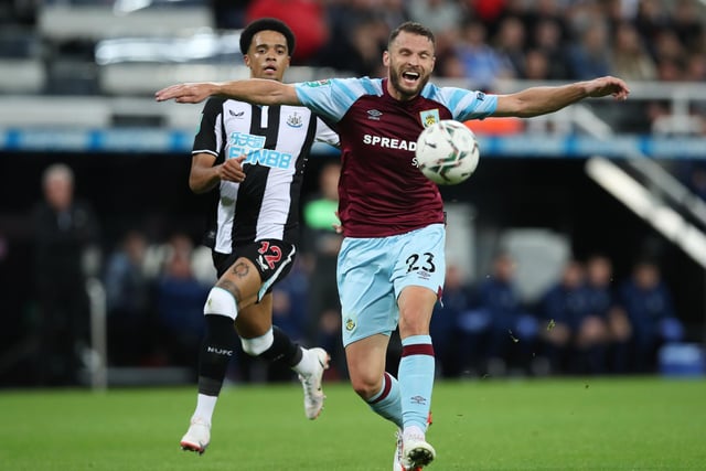 Erik Pieters of Burnley shields the ball from Jamal Lewis of Newcastle United during the Carabao Cup Second Round match between Newcastle United and Burnley at St. James Park on August 25, 2021 in Newcastle upon Tyne, England.