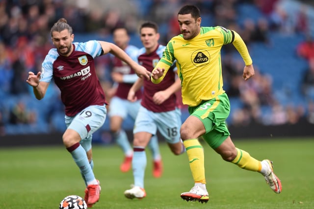 Ozan Kabak of Norwich City runs with the ball whilst under pressure from Jay Rodriguez of Burnley during the Premier League match between Burnley and Norwich City at Turf Moor on October 02, 2021 in Burnley, England.