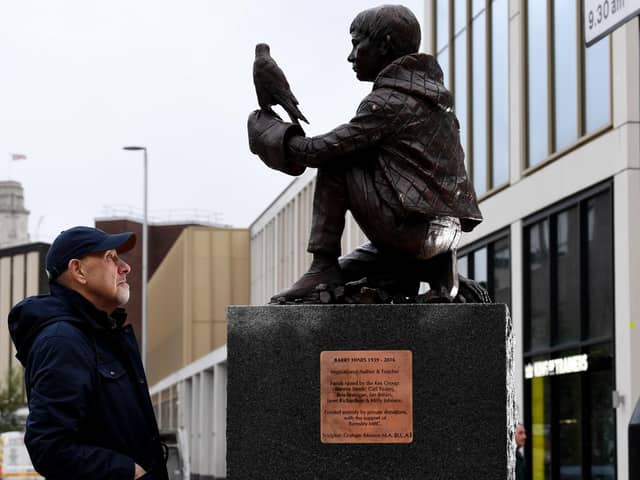 The Barry Hines Kes Statue is put in place at Cheapside, Barnsley - Graham Ibbeson is pictured with his sculpture Picture: Simon Hulme