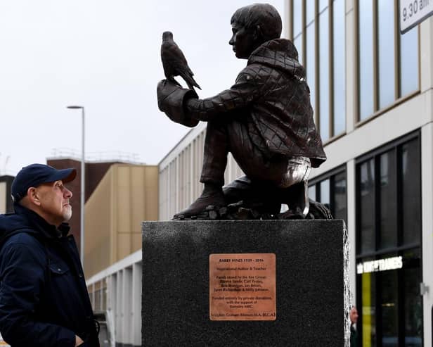 The Barry Hines Kes Statue is put in place at Cheapside, Barnsley - Graham Ibbeson is pictured with his sculpture  Picture: Simon Hulme