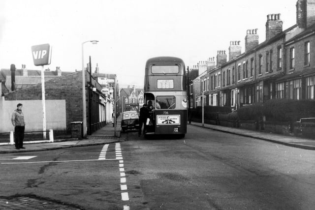 Queen's Road on the corner with Royal Park Road in December 1968. People are getting on a number 56 North Lane bus. A parked van and a man looking at the camera.