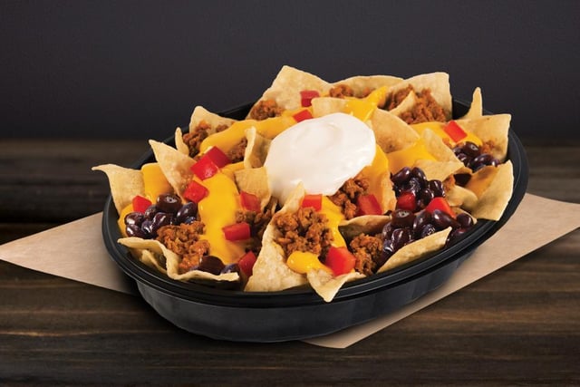 Nachos are a rare offering in most fast food restaurants, so it's only right they make the list of top ten items you can buy at Taco Bell. This large portion of seasoned nachos topped with warm nacho cheese sauce, black beans, seasoned beef, diced tomatoes and sour cream is the perfect late-night sharer